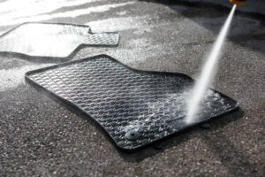 Man cleaning car mats at a carwash